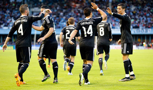 Real Madrid players walking back to their half of the pitch after goal celebrations