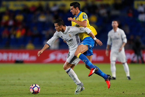 Ronaldo running with a defender climbing on his back