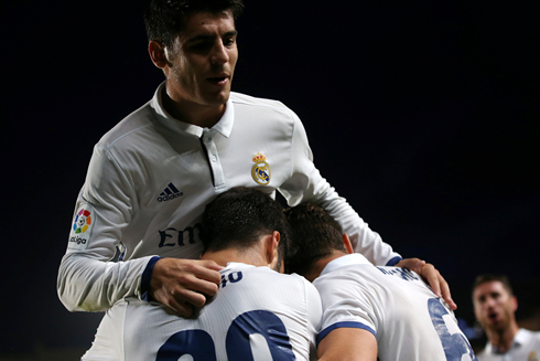 Real Madrid players celebrate a league goal in group