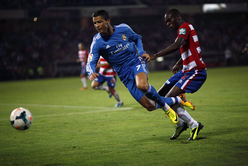 Cristiano Ronaldo being brought down with a soccer tackle