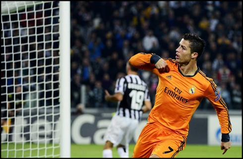 Cristiano Ronaldo in an orange Real Madrid jersey and kit for 2013-2014