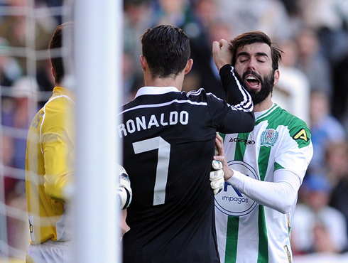 Cristiano Ronaldo punching an opponent during a game