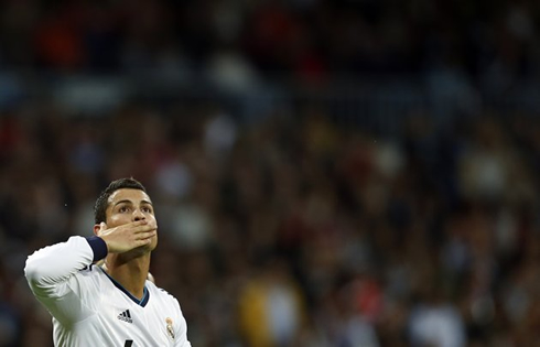 Cristiano Ronaldo throwing kisses during a goal celebration in a Real Madrid wallpaper 2012-2013