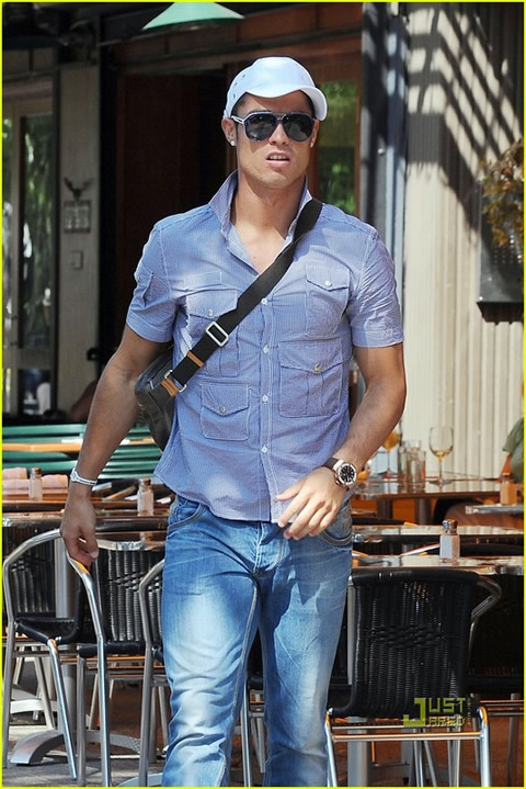 Cristiano Ronaldo fashion in a purple shirt and wearing a cap